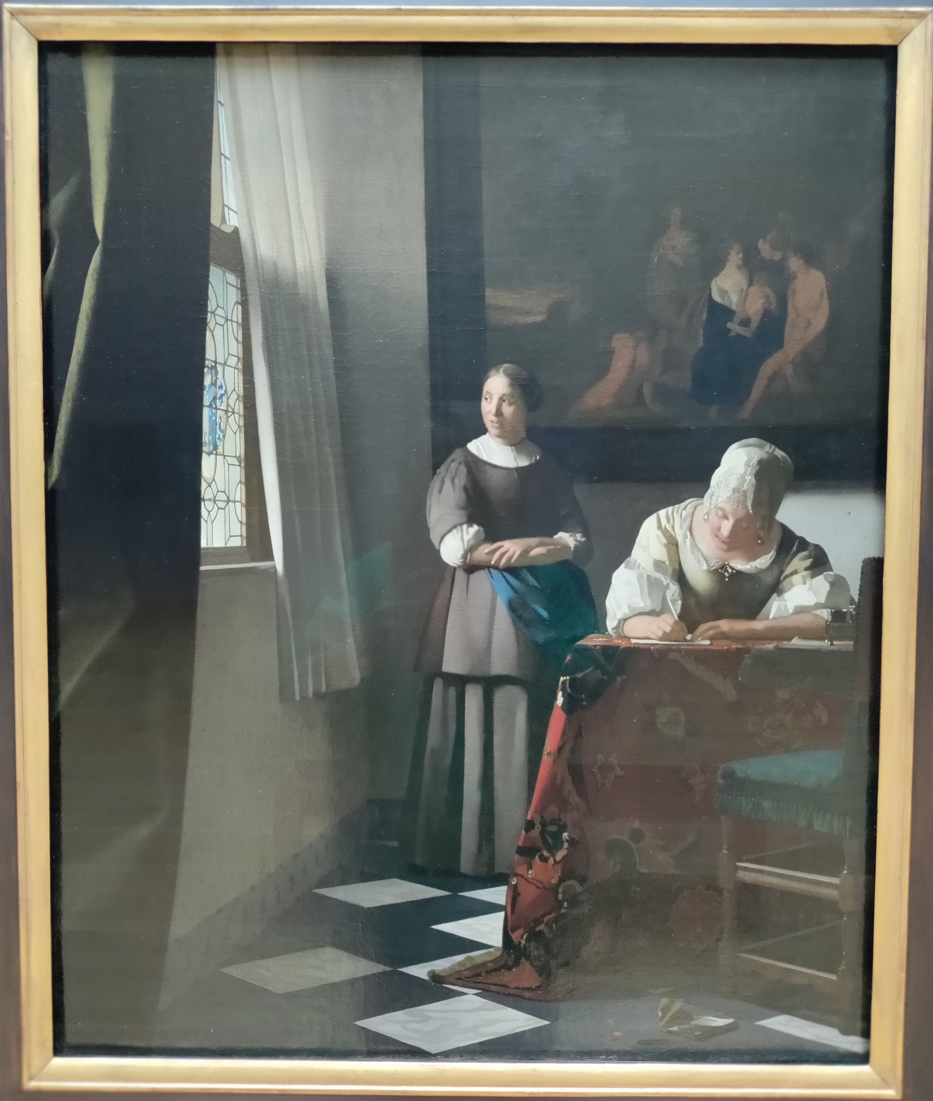 A Lady Writing a Letter with Her Maid by Johannes Vermeer.